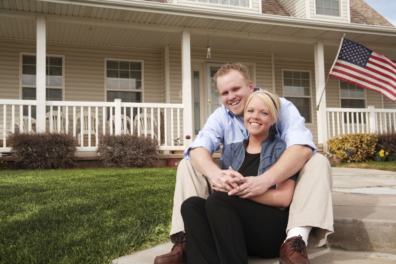 Happy Couple in front of house
